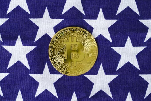 Crypto currency concept. Gold Bitcoin coin on flag of United States of America USA