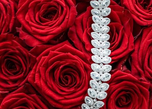 Gemstone jewellery, wedding fashion and luxe shopping concept - Luxury diamond bracelet and bouquet of red roses, jewelry love gift on Valentines Day and romantic holidays present