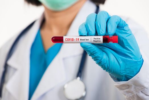 Doctor scientist in white uniform wear a mask holding test tube Coronavirus test blood sample in a clinical laboratory for analyzing isolated on white, medicine COVID-19 pandemic outbreak concept