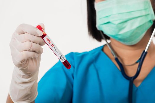 Nurse in blue uniform wear a mask holding test tube sample Coronavirus test blood in the laboratory for analyzing isolated on white background, medicine COVID-19 pandemic outbreak concept