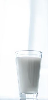 Dairy, healthy nutrition and breakfast concept - World Milk Day, full glass on marble table