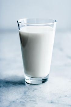 Dairy, healthy nutrition and breakfast concept - World Milk Day, full glass on marble table