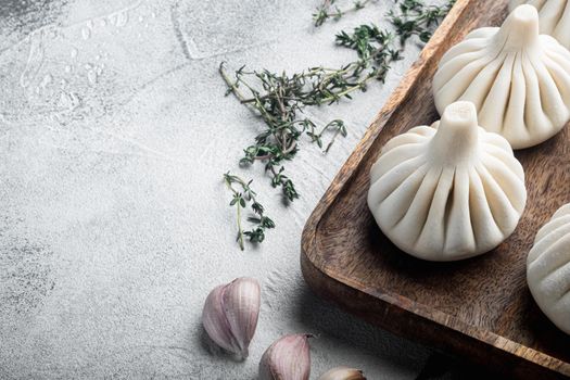 Uncooked Baozi chinese dumplings. Azian dumplings set, on gray stone background, with copy space for text