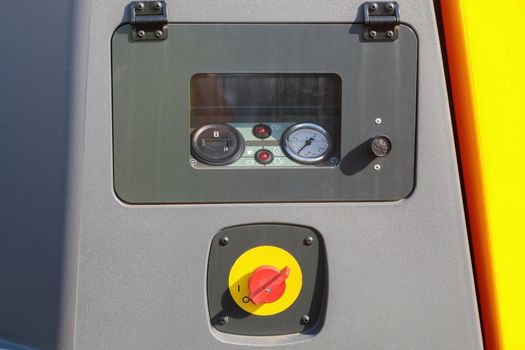 Pressure gauge measuring instruments on air compressor control panel close up.