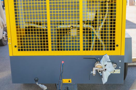 Mobile diesel compressor on wheels for supplying pneumatic air to devices.