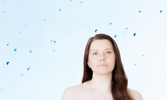 Rejuvenation skincare and beauty ad, beauty face portrait of young woman with healthy clean skin, blue cosmetic liquid drops on background.