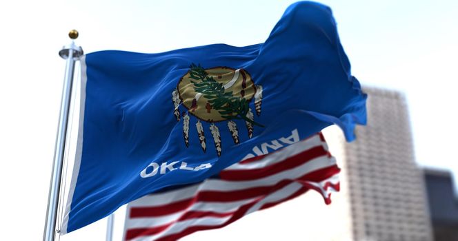 The flags of the Oklahoma state and United States of America waving in the wind. Democracy and independence. American state.