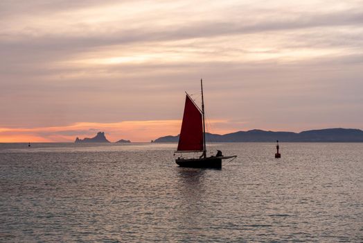 Sailing boat on the Island of Formentera in the summer of 2021 with Es Vedra behind.