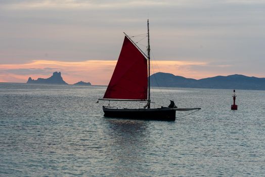 Sailing boat on the Island of Formentera in the summer of 2021 with Es Vedra behind.