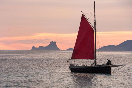 Sailing boat on the Island of Formentera in the summer of 2021 with Es Vedra behind.