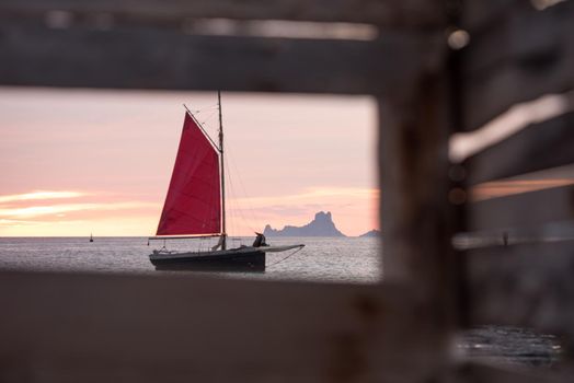 Sailing boat on the Island of Formentera in the summer of 2021 with Es Vedra behind.