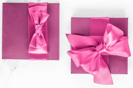 Birthday, wedding and girly branding concept - Pink gift box with silk bow on marble background, girl baby shower present and glamour fashion gift for luxury beauty brand, holiday flatlay art design