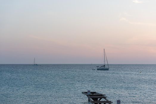 Fromentera, Spain : 2021 June 11 : Boats in  the Wonderful sunset on the beach of Ses Illetes on the Island of Formentera in Spain.