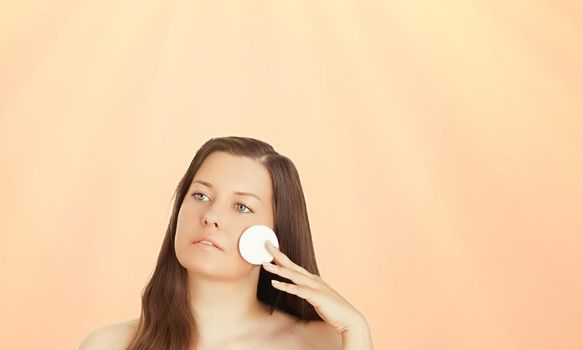 Sunny face portrait of young woman, suntan skin tone and beauty cosmetics. Beautiful brunette female model with natural tan using sunscreen product.