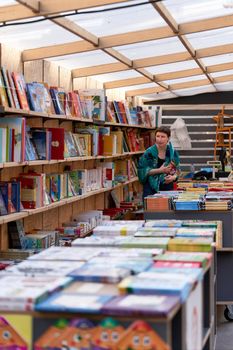 Saint Petersburg, Russia - June 10, 2021: A selection of books sold at the book fair, books are spelled out in Cyrillic