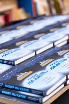 Saint Petersburg, Russia - June 10, 2021: A selection of books sold at the book fair, books are spelled out in Cyrillic