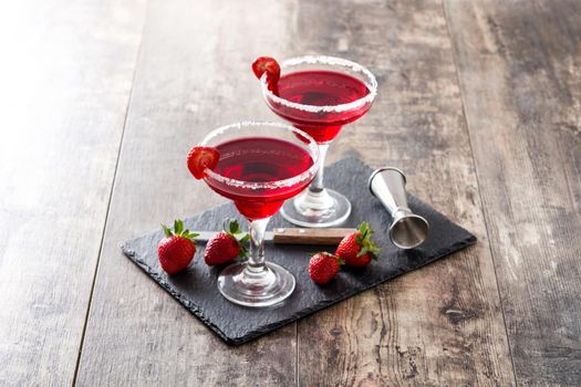 Strawberry cocktail drink in glass on wooden table