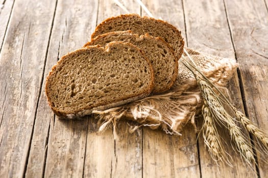 Fresh rye bread on wooden table