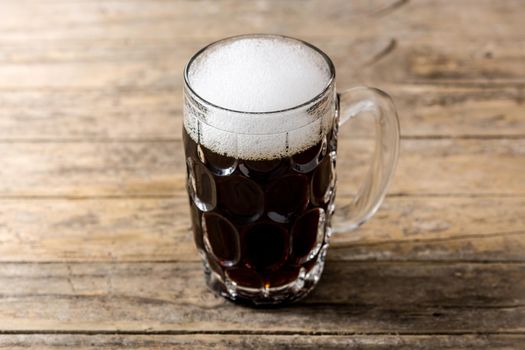 Traditional kvass beer mug with rye bread on wooden table