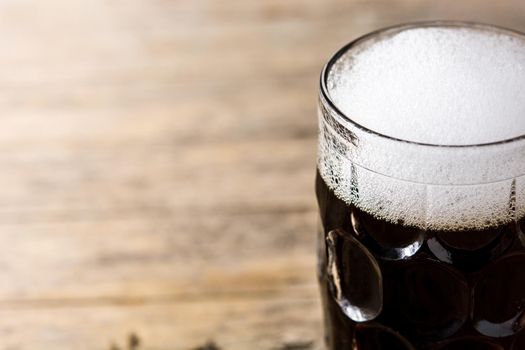 Traditional kvass beer mug with rye bread on wooden table