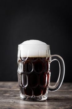 Traditional kvass beer mug with rye bread on wooden table