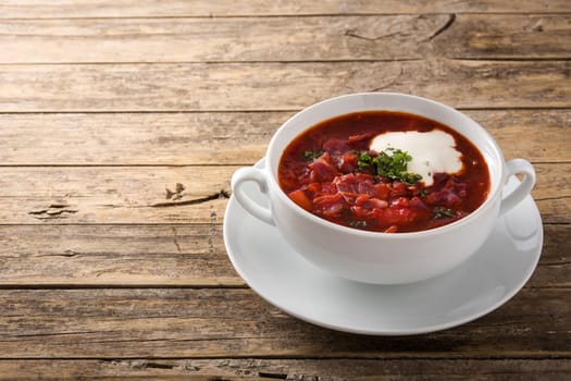 Traditional Ukrainian Russian borsch. Beetroot soup on wooden table