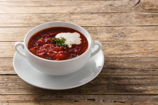 Traditional Ukrainian Russian borsch. Beetroot soup on wooden table