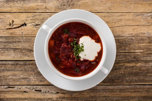 Traditional Ukrainian Russian borsch. Beetroot soup on wooden table