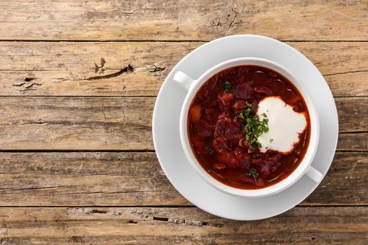 Traditional Ukrainian Russian borsch. Beetroot soup on wooden table