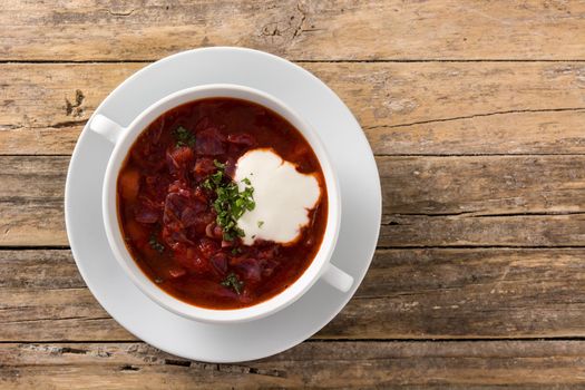 Traditional Ukrainian Russian borsch. Beetroot soup on wooden table