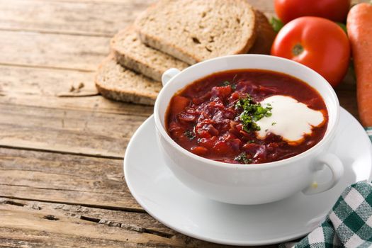 Traditional Ukrainian Russian borsch. Beetroot soup on wooden table