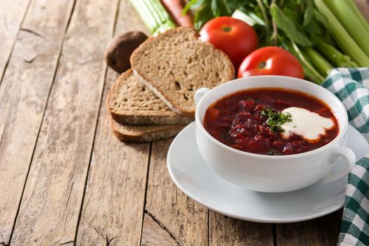 Traditional Ukrainian Russian borsch. Beetroot soup on wooden table