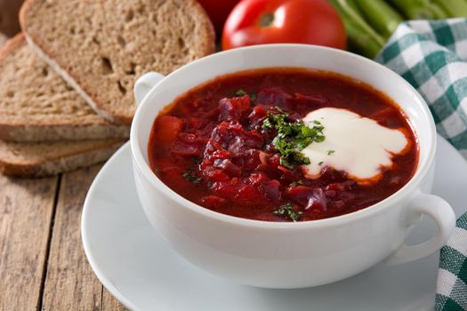 Traditional Ukrainian Russian borsch. Beetroot soup on wooden table