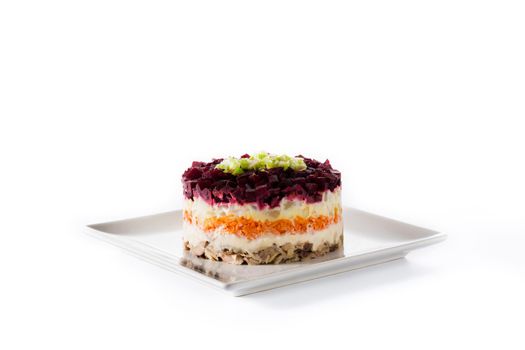 Traditional Russian herring salad with beetroot and carrots isolated on white background