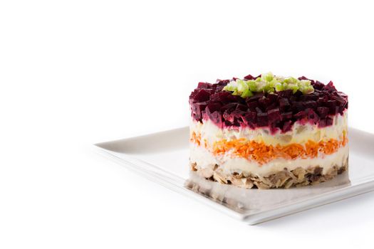 Traditional Russian herring salad with beetroot and carrots isolated on white background