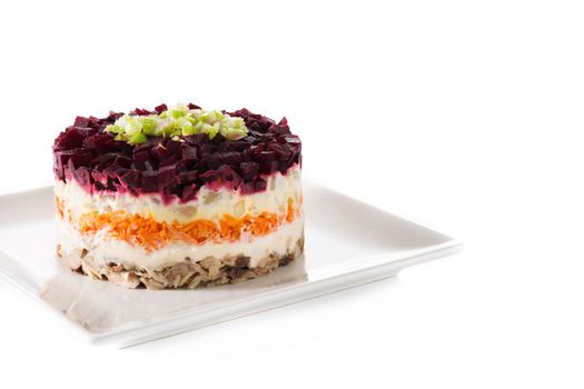 Traditional Russian herring salad with beetroot and carrots isolated on white background