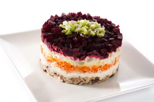 Traditional Russian herring salad with beetroot and carrots isolated on white background