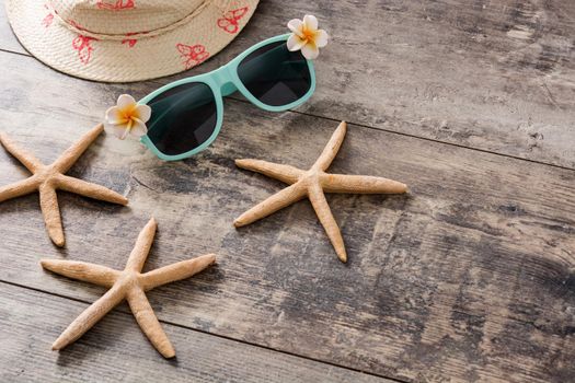Sunglasses,starfish and summer hat on wooden background