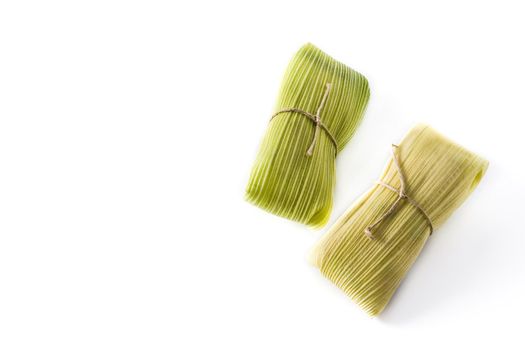 Mexican corn and chicken tamales isolated on white background.