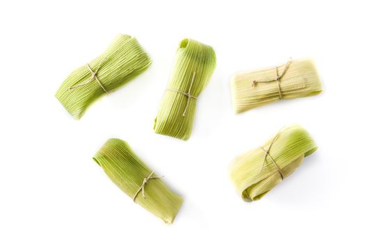 Mexican corn and chicken tamales isolated on white background.