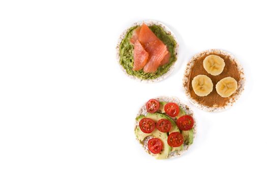 Puffed rice cakes with guacamole salmon,tomato and avocado, and banana with peanut butter isolated on white background