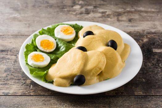 Traditionoundal Peruvian papa a la huancaina on wooden table