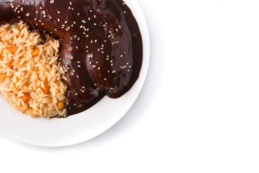 Traditional mole Poblano with rice in plate isolated on white background.