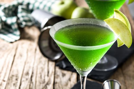 Green appletini cocktail on wooden table