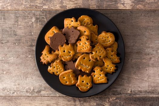 Funny Halloween cookies on wooden table