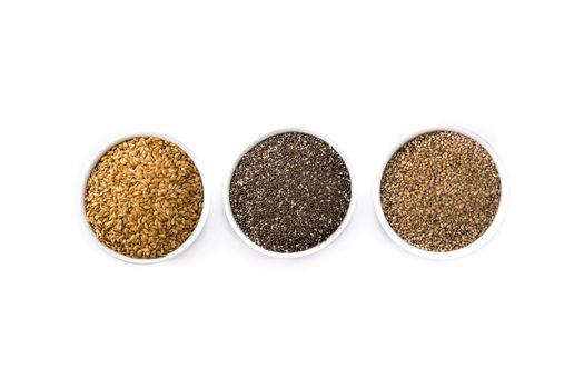 Assortment of different seeds in bowl isolated on white background. Linen, chia and sesame seeds isolated on white background