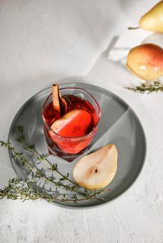 Homemade hot sliced pear with a cinnamon stick on a white background