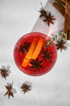 Orange cocktail with rum, liquor, pear slices and rosemary on white table, selective focus