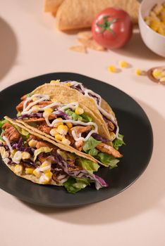 Traditional mexican taco with meat and vegetables. Latin american food.