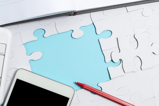 Building An Unfinished White Jigsaw Pattern Puzzle With Missing Last Piece